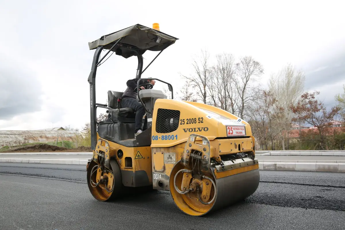 Roller compacting new asphalt